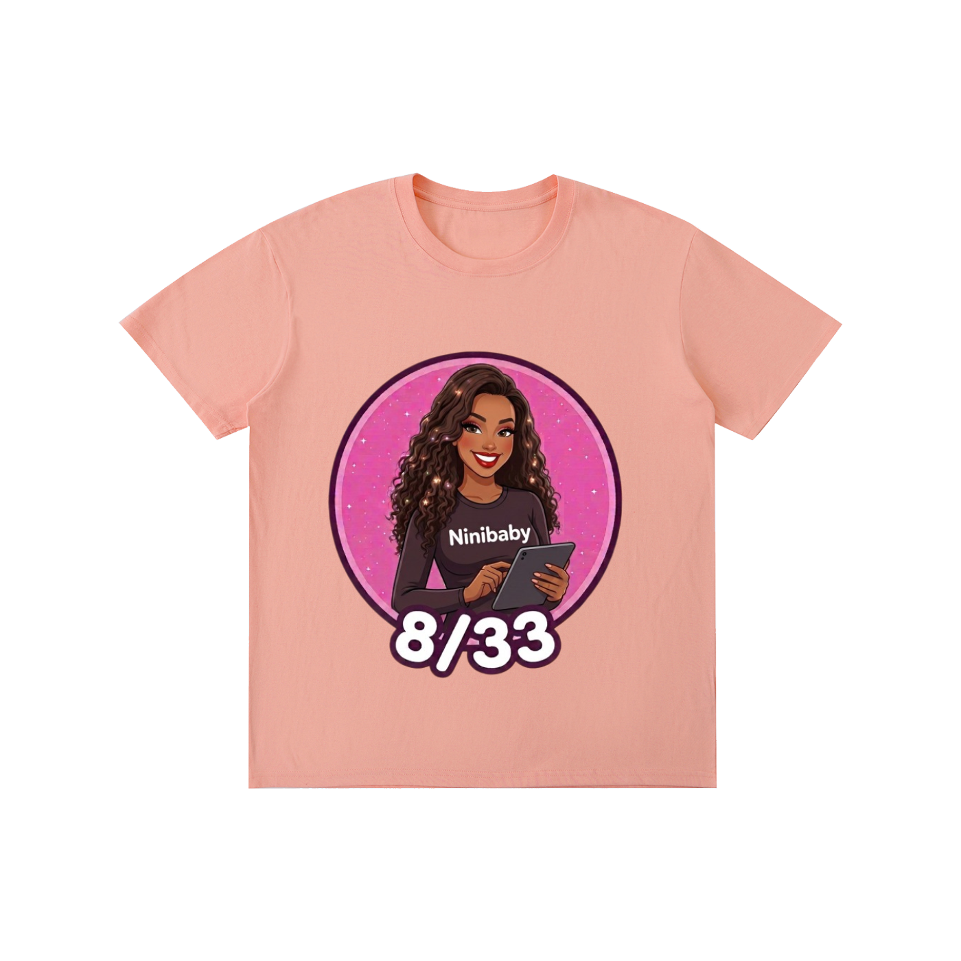 A light peach-pink short-sleeve t-shirt with a circular graphic print on the front. The graphic features an illustration of a woman with long dark curly hair holding a tablet, with the text 'Ninibaby' on her shirt, set against a pink starry background.
