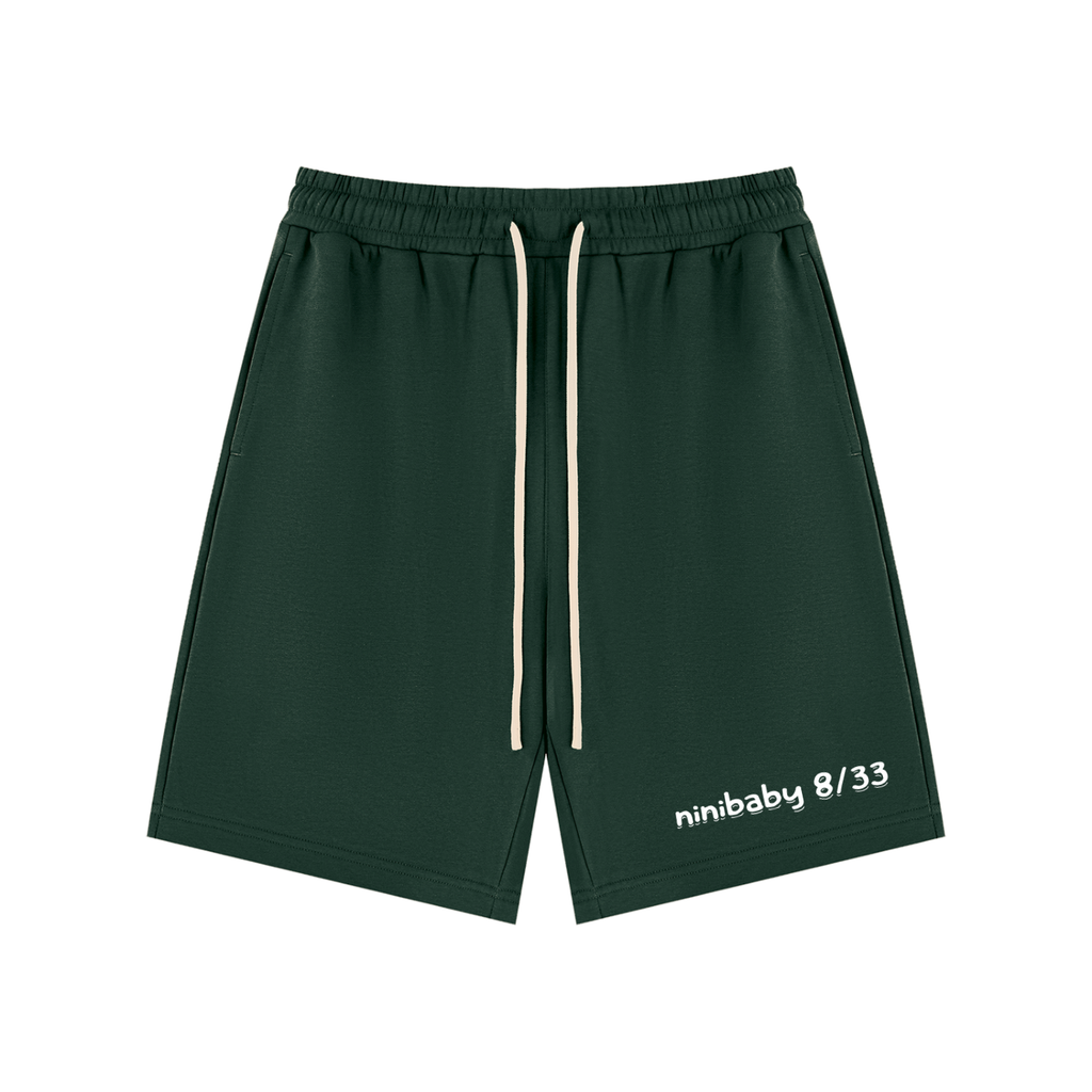 Green athletic shorts with a brand logo on a light gray background