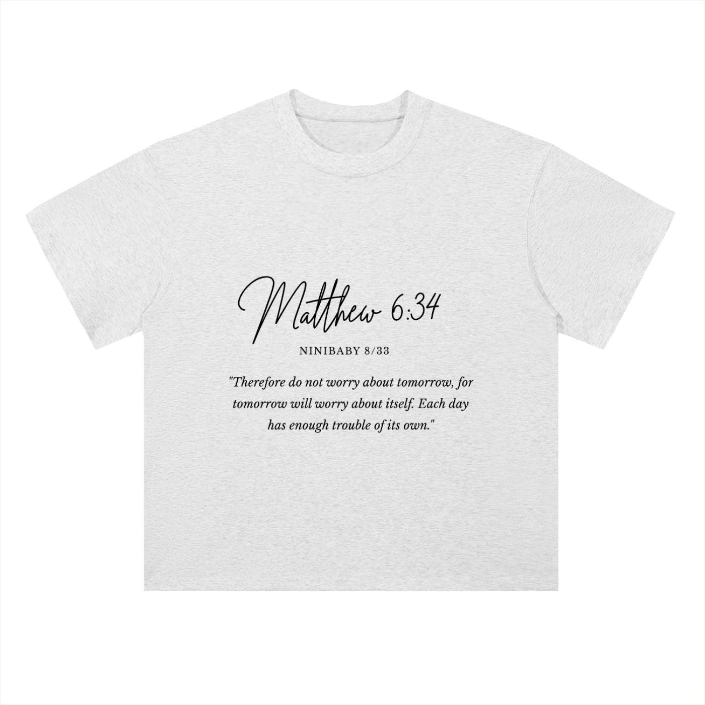 A light gray heather crewneck t-shirt featuring a black printed graphic on the front with the Bible verse Matthew 6:34.