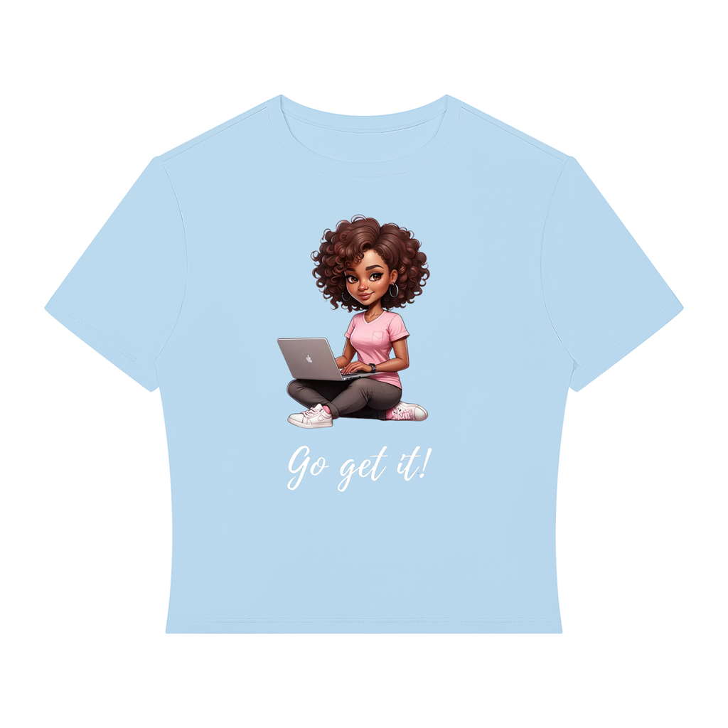 A light blue short-sleeve t-shirt with a cartoon graphic of a woman with curly brown hair sitting cross-legged and using a laptop, with the text 'Go get it!' printed below in white script.