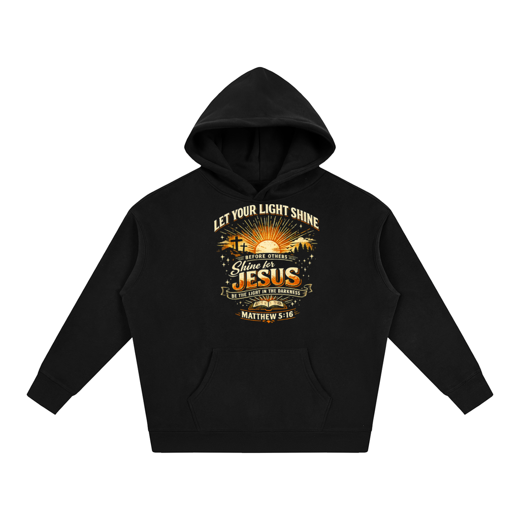 A black pullover hoodie with a front graphic print featuring the text 'LET YOUR LIGHT SHINE' and 'Glow in the DARKS JESUS IS THE LIGHT OF THE WORLD' with a sunrise design, shown on a plain white background.