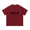 Red t-shirt with black text on a white background