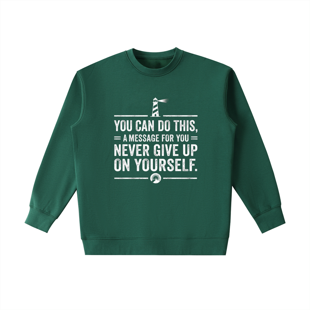 A dark green crewneck sweatshirt with a white graphic print on the front featuring a lighthouse and the motivational quote 'YOU CAN DO THIS, A MESSAGE FOR YOU NEVER GIVE UP ON YOURSELF.'.