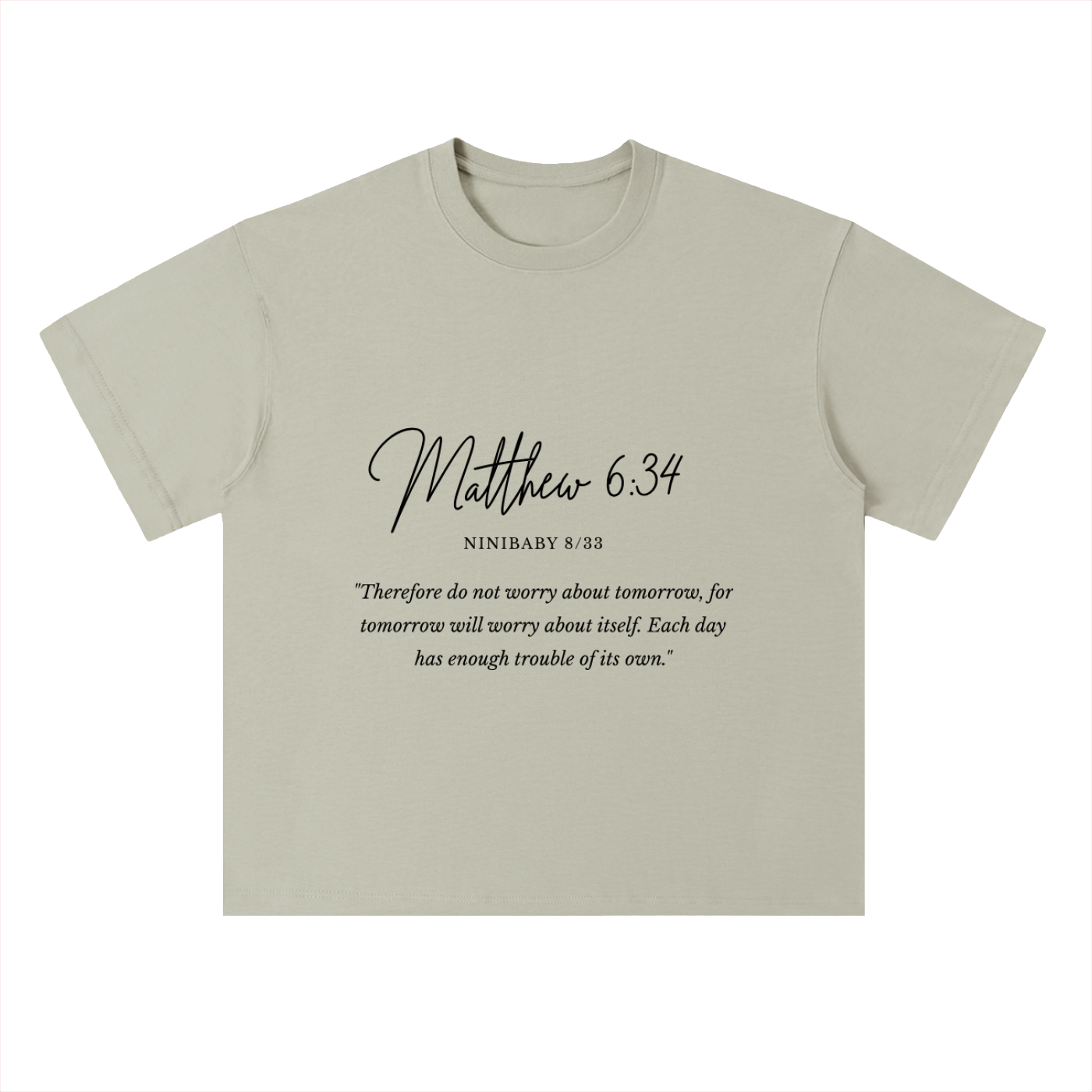 A light sage green crewneck t-shirt with a black printed Bible verse from Matthew 6:34 on the front, displayed against a solid white background.